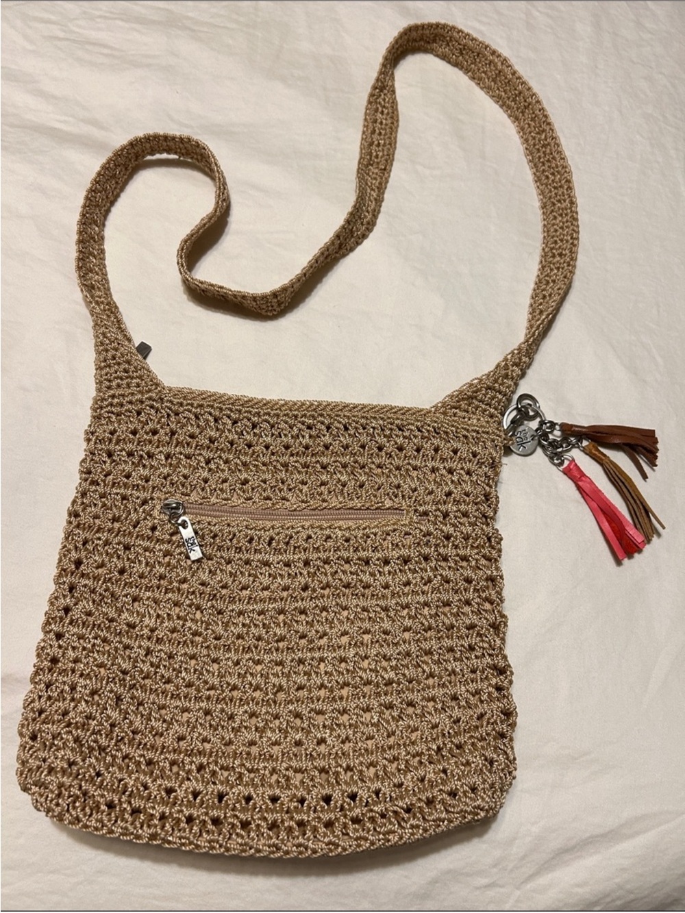 The Sak Woven Crossbody Bag in Tan with pink & brown tassels